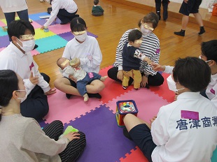 ベビーちゃんにミルクを飲ませている高校生