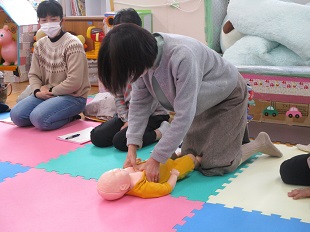 乳児の胸骨圧迫の指導を受けるようす